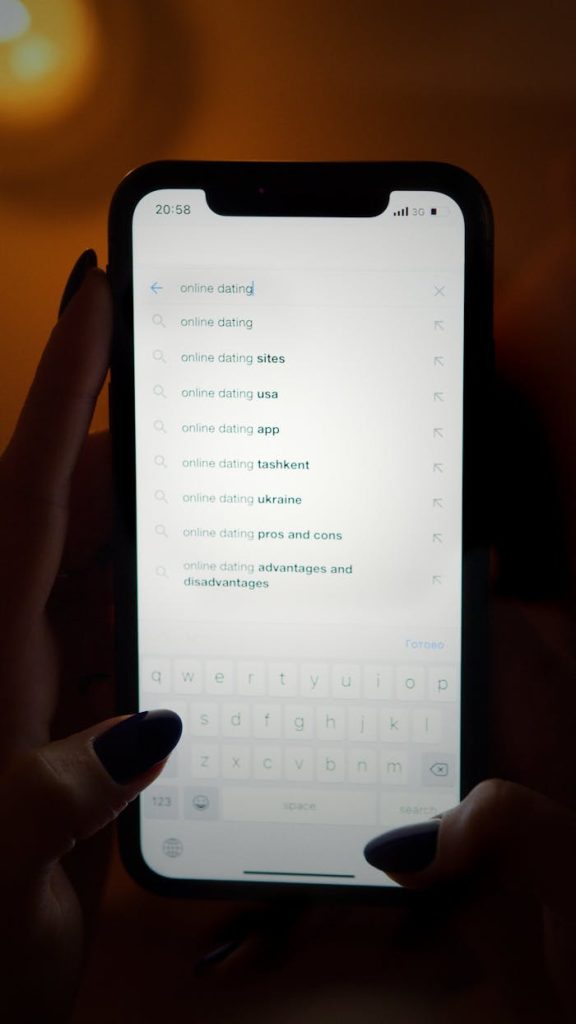 Person browsing online dating options on a smartphone screen at night.